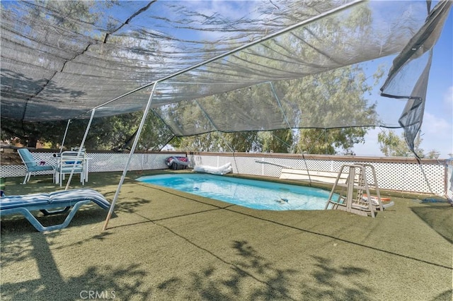 view of pool with a lawn, fence, and a fenced in pool