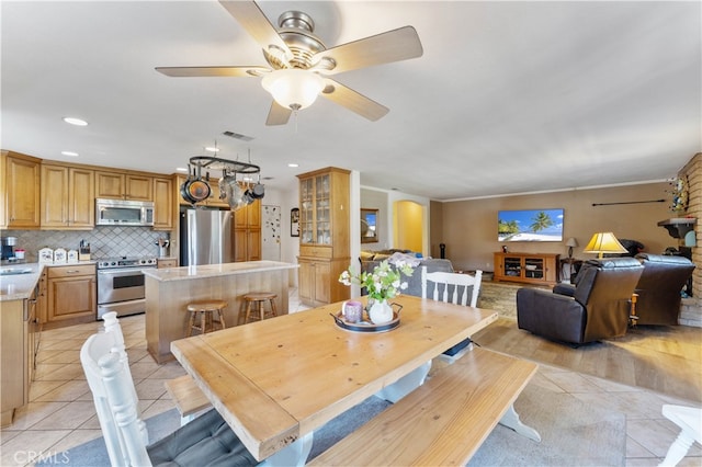 tiled dining area featuring ceiling fan