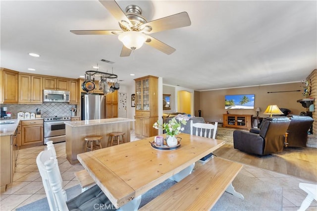 dining area featuring arched walkways, light tile patterned floors, recessed lighting, visible vents, and ceiling fan