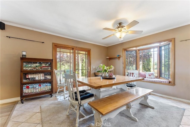 dining room with light tile patterned floors, ornamental molding, and plenty of natural light