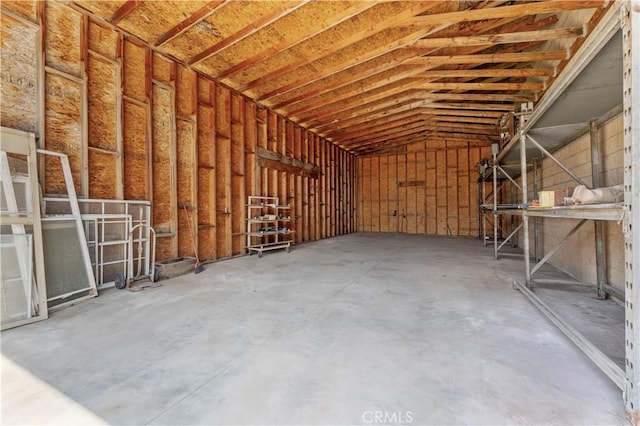 miscellaneous room featuring lofted ceiling and concrete floors
