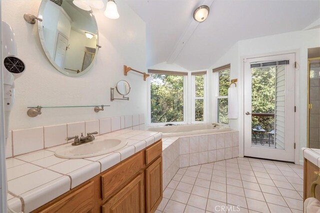 39309 Forest Park Ln, Oakhurst, CA 93644 - full bathroom with vanity, lofted ceiling with beams, a relaxing tiled tub, and tile patterned floors