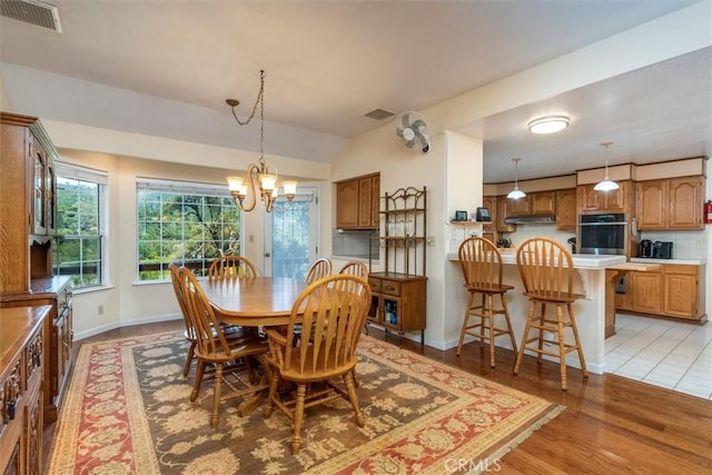 39309 Forest Park Ln, Oakhurst, CA 93644 - dining area featuring an inviting chandelier, light wood finished floors, baseboards, and visible vents
