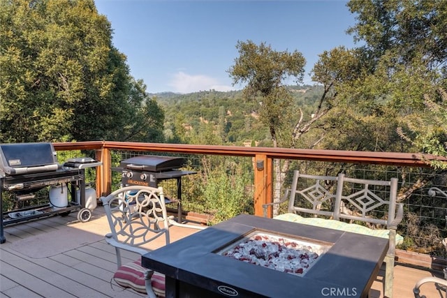 39309 Forest Park Ln, Oakhurst, CA 93644 - wooden terrace with an outdoor fire pit and a view of trees