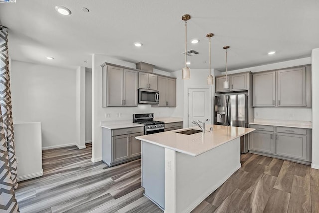 kitchen featuring pendant lighting, sink, dark wood-type flooring, and stainless steel appliances