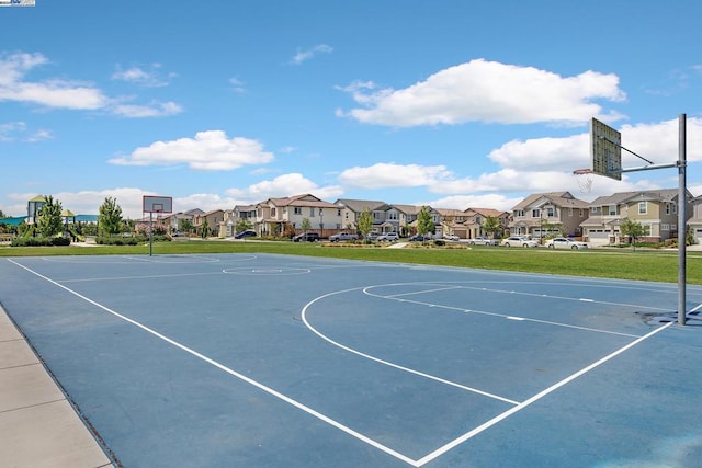 view of basketball court with a lawn