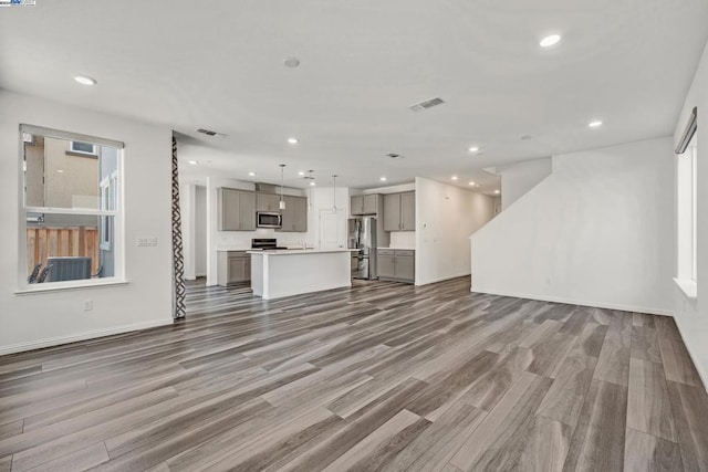 unfurnished living room with hardwood / wood-style floors