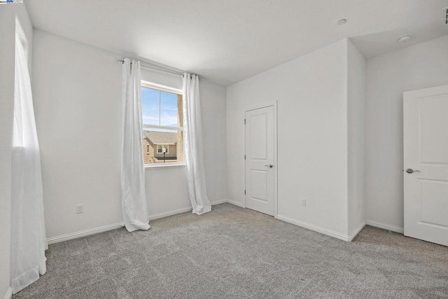 unfurnished bedroom featuring light carpet