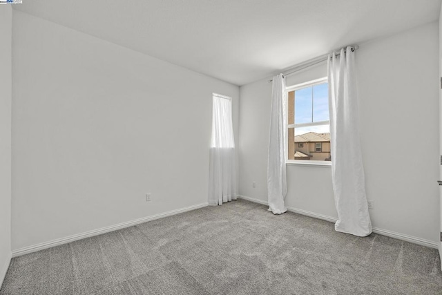 unfurnished room with light carpet