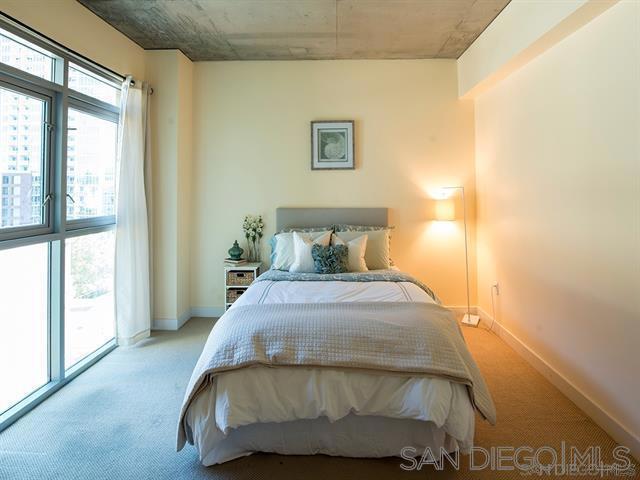 bedroom with light colored carpet and access to exterior