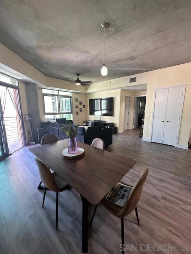 dining area featuring wood-type flooring and ceiling fan