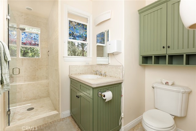 bathroom featuring an enclosed shower, vanity, and toilet