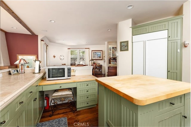 kitchen featuring butcher block counters, a center island, and green cabinetry