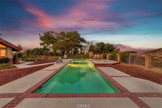 view of pool at dusk