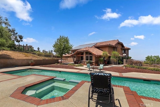 view of swimming pool featuring an in ground hot tub and a patio