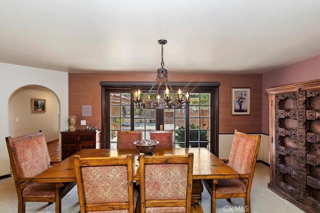 dining room featuring carpet floors and a notable chandelier