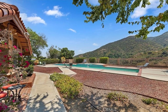 view of pool with a patio area and a mountain view