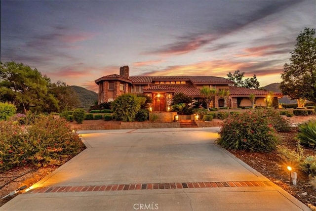 mediterranean / spanish house with a mountain view