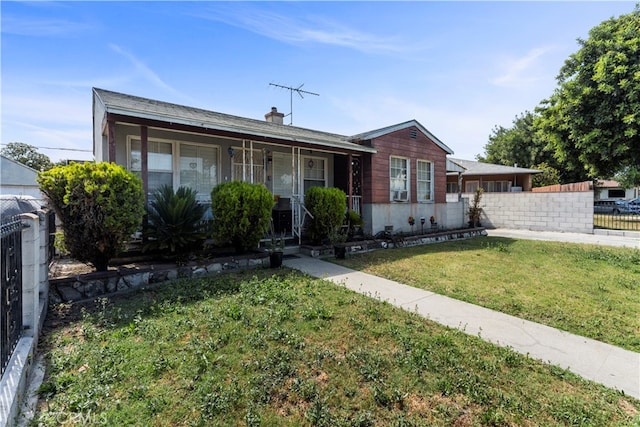 single story home featuring a front lawn and a porch