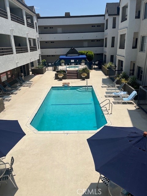 view of swimming pool with a patio