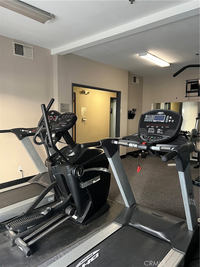 exercise room with a textured ceiling