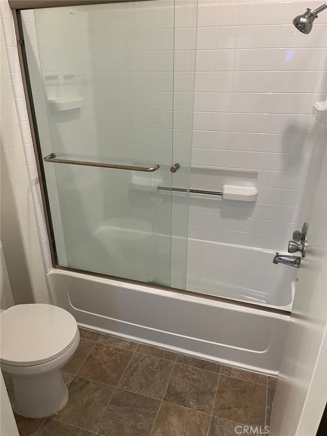 bathroom with combined bath / shower with glass door and toilet