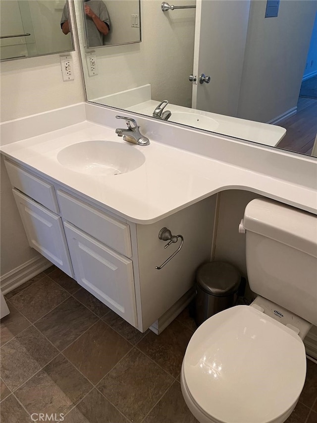 bathroom featuring tile patterned flooring, vanity, and toilet