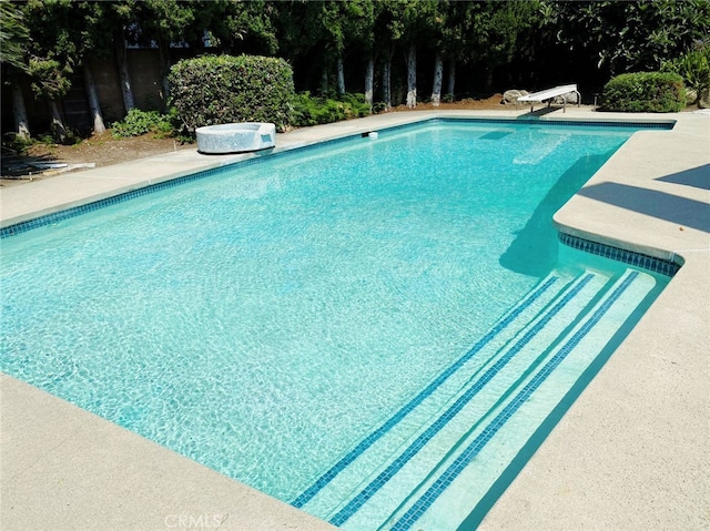 view of pool with a diving board