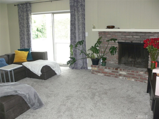 bedroom with a brick fireplace and carpet