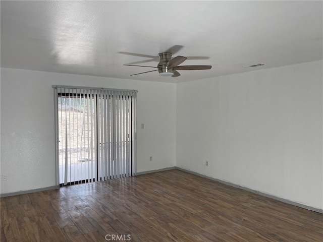 spare room featuring dark hardwood / wood-style floors and ceiling fan