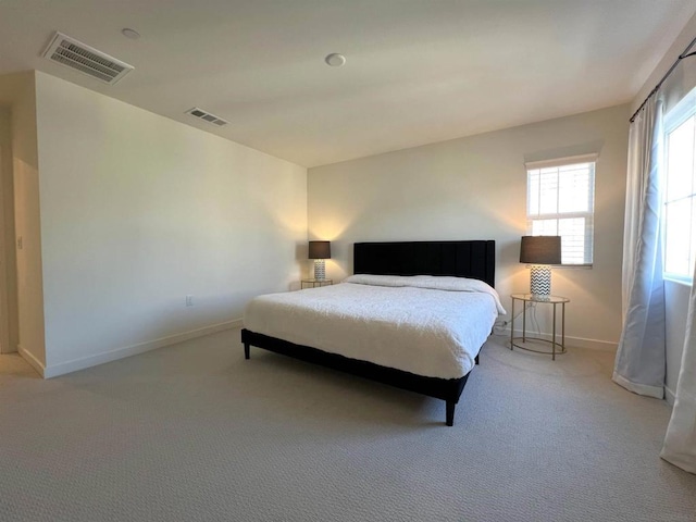 bedroom featuring light colored carpet