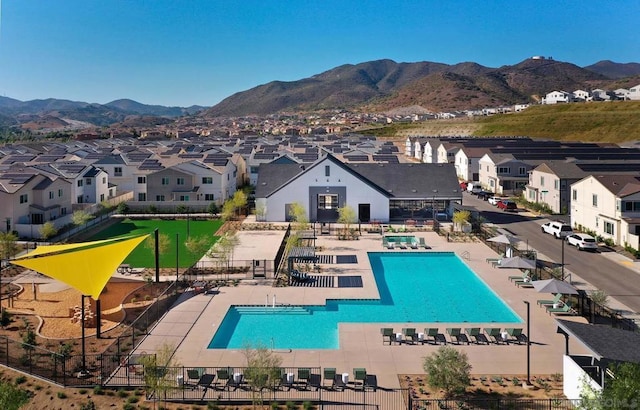 view of swimming pool with a mountain view and a patio