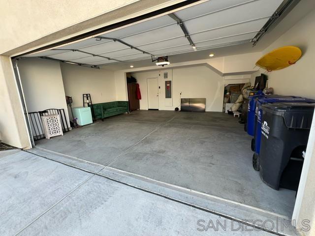 garage featuring a garage door opener and electric panel