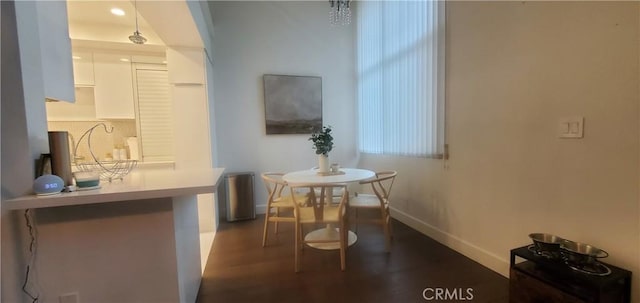 dining space with dark wood-style floors and baseboards