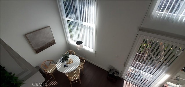 interior space with dark wood-style flooring and baseboards