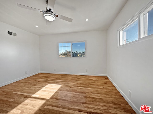 empty room featuring ceiling fan and light wood-type flooring