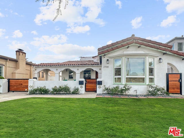 mediterranean / spanish-style home with a front yard