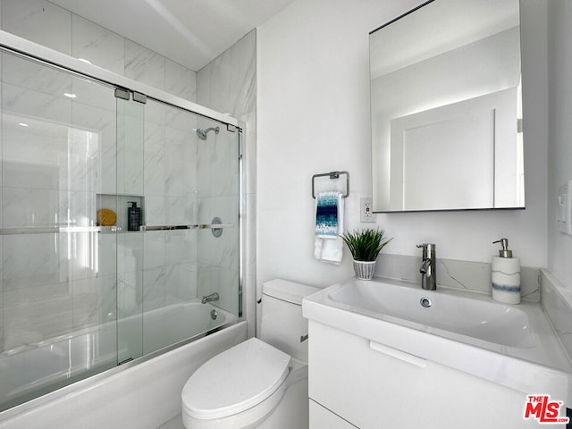 full bathroom with toilet, bath / shower combo with glass door, and vanity