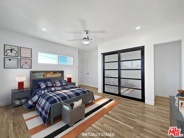 bedroom featuring wood-type flooring and ceiling fan