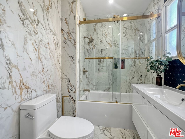 full bathroom featuring tile walls, vanity, enclosed tub / shower combo, and toilet