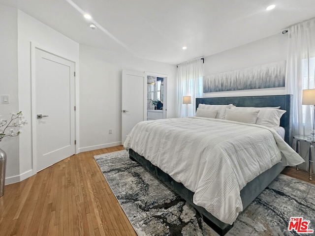 bedroom with hardwood / wood-style floors