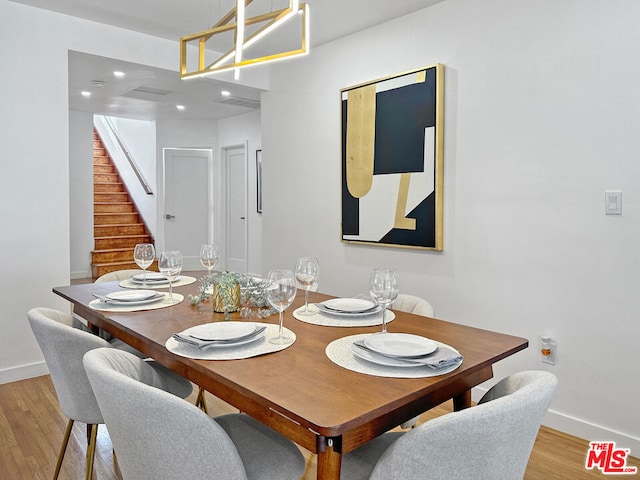 dining room featuring an inviting chandelier and light hardwood / wood-style floors