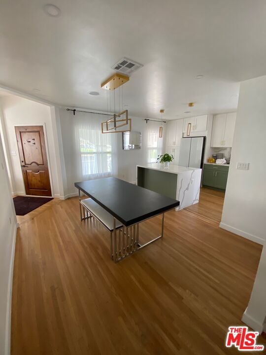 game room with a healthy amount of sunlight and light wood-type flooring