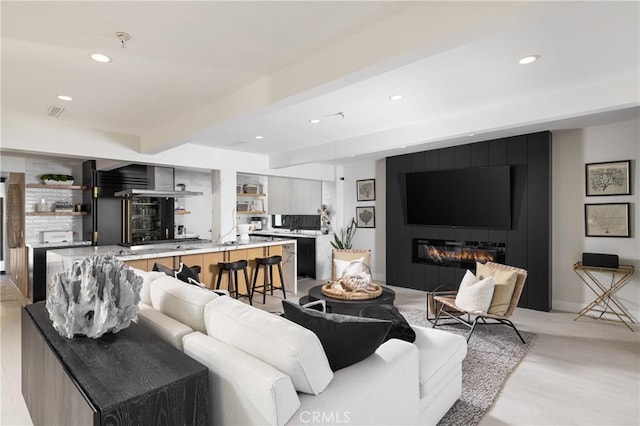35651 Beach Rd, Dana Point, CA 92624 - living room featuring recessed lighting, beam ceiling, baseboards, and a large fireplace