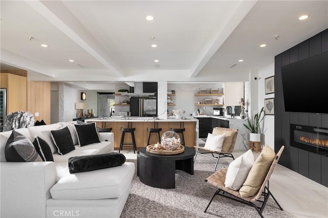 living room with sink, a fireplace, and light carpet