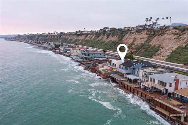 aerial view at dusk featuring a water view