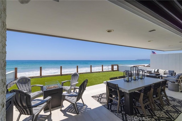 35651 Beach Rd, Dana Point, CA 92624 - view of patio with an outdoor fire pit, outdoor dining area, and a water view