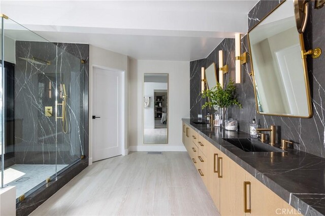 35651 Beach Rd, Dana Point, CA 92624 - bathroom with vanity, a marble finish shower, wood finished floors, and backsplash