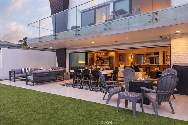 patio terrace at dusk featuring an outdoor hangout area