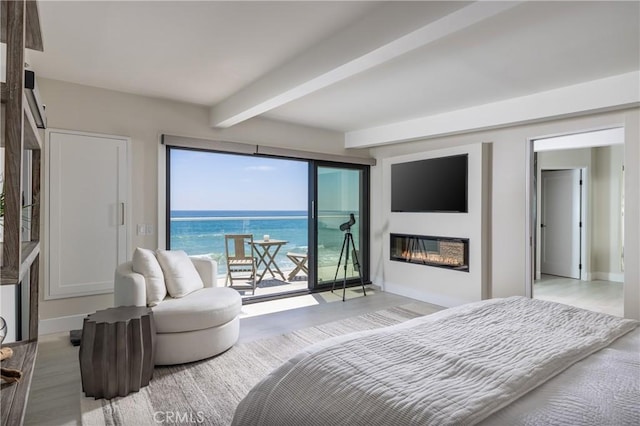 bedroom with access to exterior, light hardwood / wood-style floors, and beamed ceiling